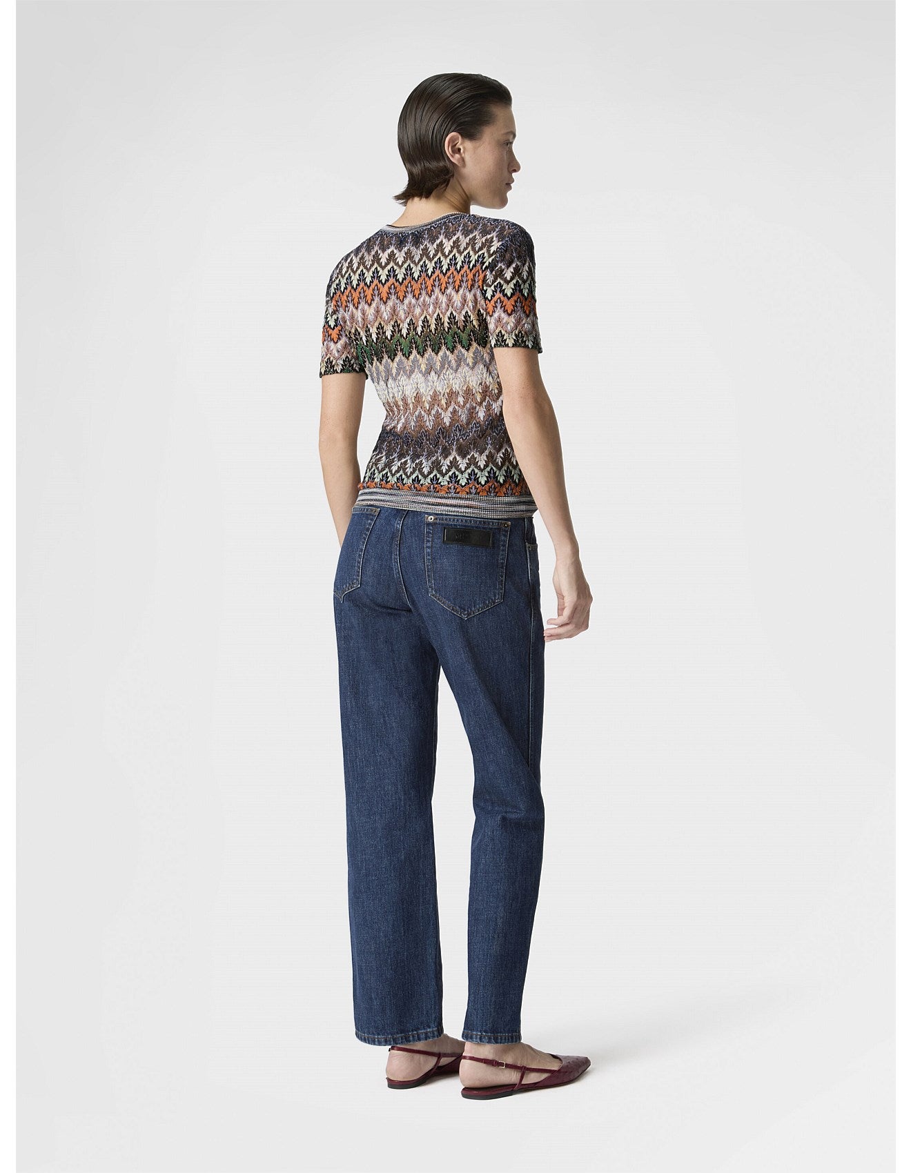 Woman wearing Missoni patterned short sleeve with zig zag pattern and blue jeans 