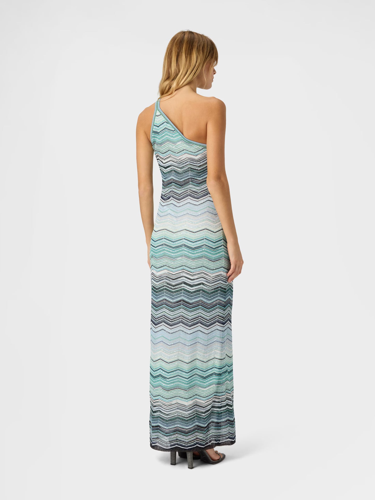 Woman wearing One shoulder turquoise Missoni zigzag patterned dress 